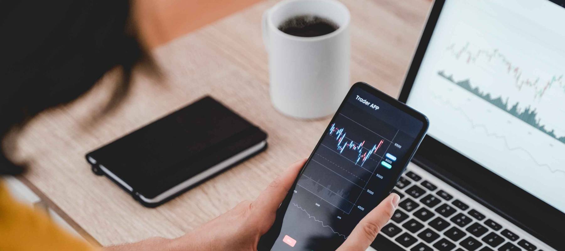 Trader business woman using trading stock market exchange app - Bitcoin, global economy concept - Focus on hands holding mobile phone