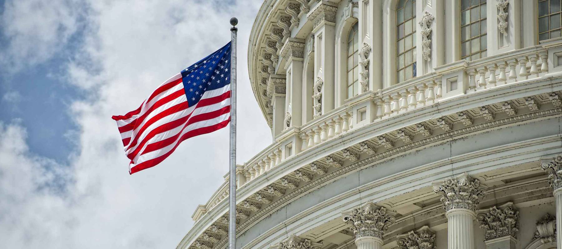 Washington DC Capitol dome detail with waving american flag