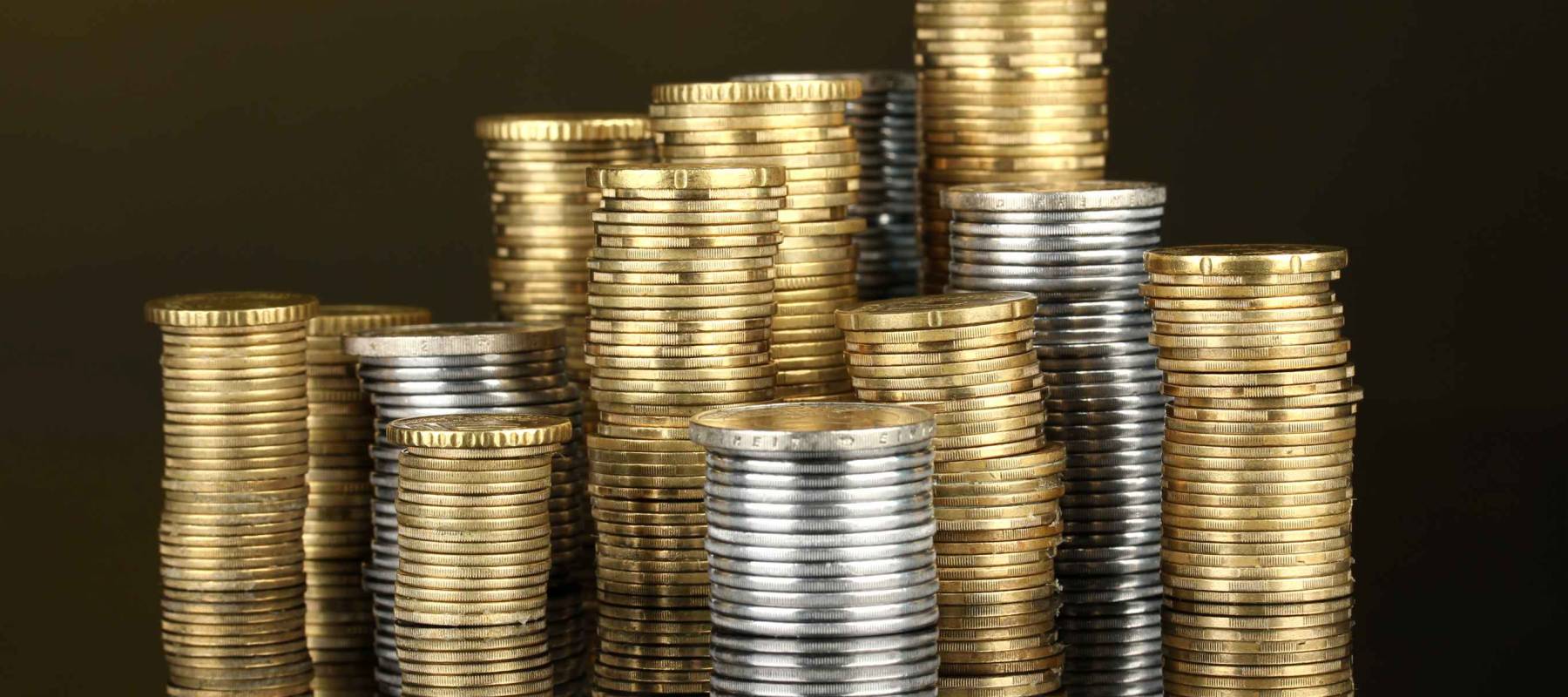 Many coins in columns on dark background