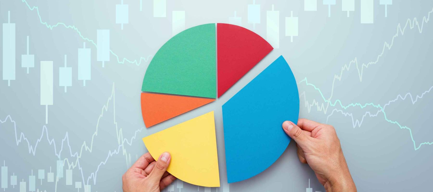 Strategy of diversified investment.  Investor managing portfolio. Pie chart and candlestick charts.