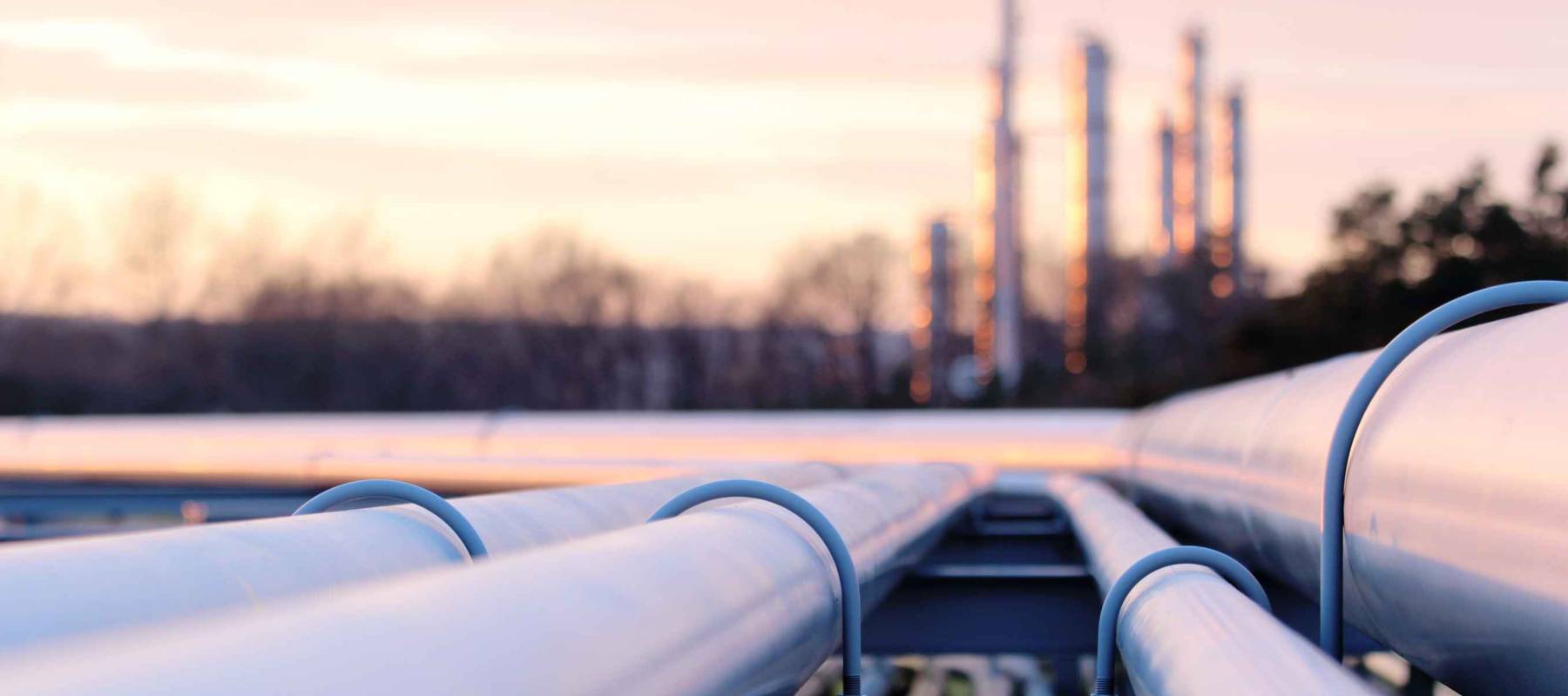 steel long pipes in crude oil factory during sunset