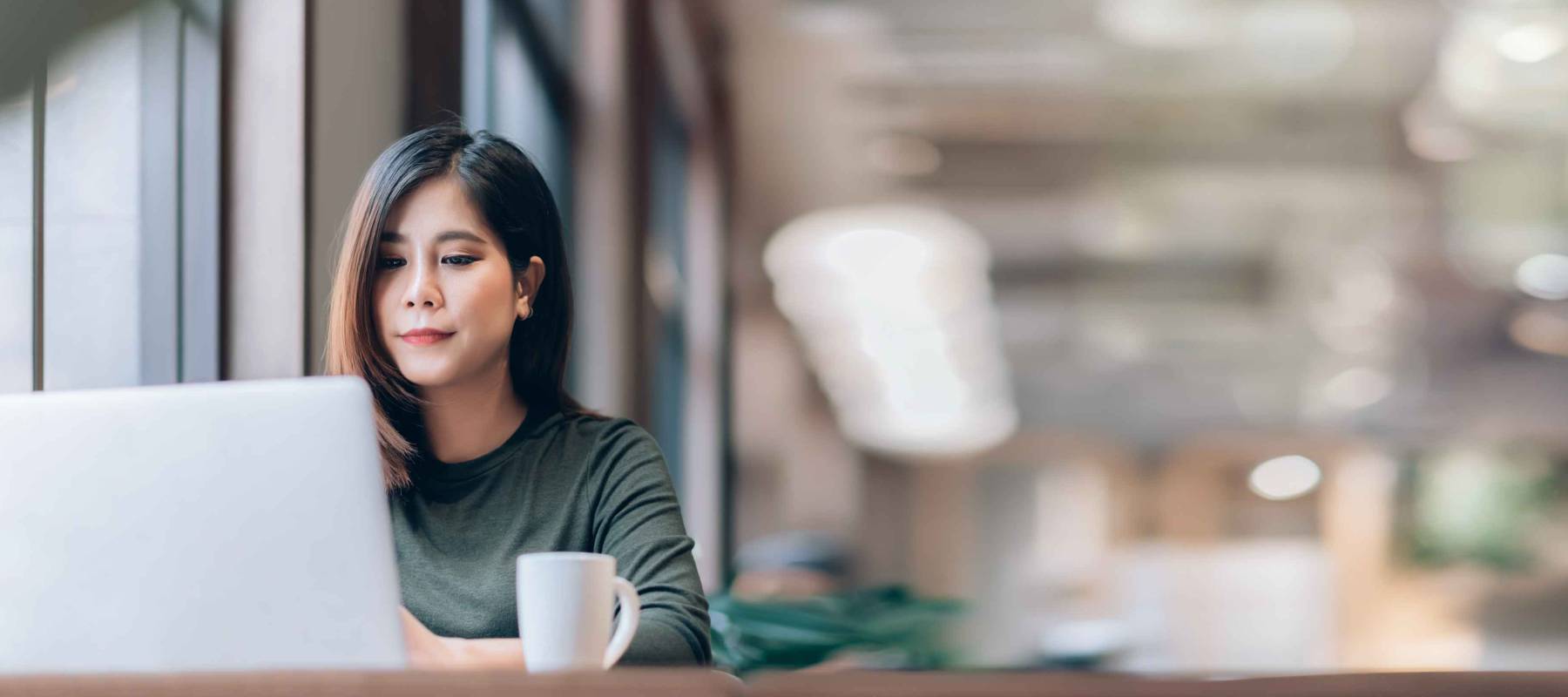 Portrait of Young Smart Asian Woman Freelance Online Working from Home with Laptop at Home Living Room