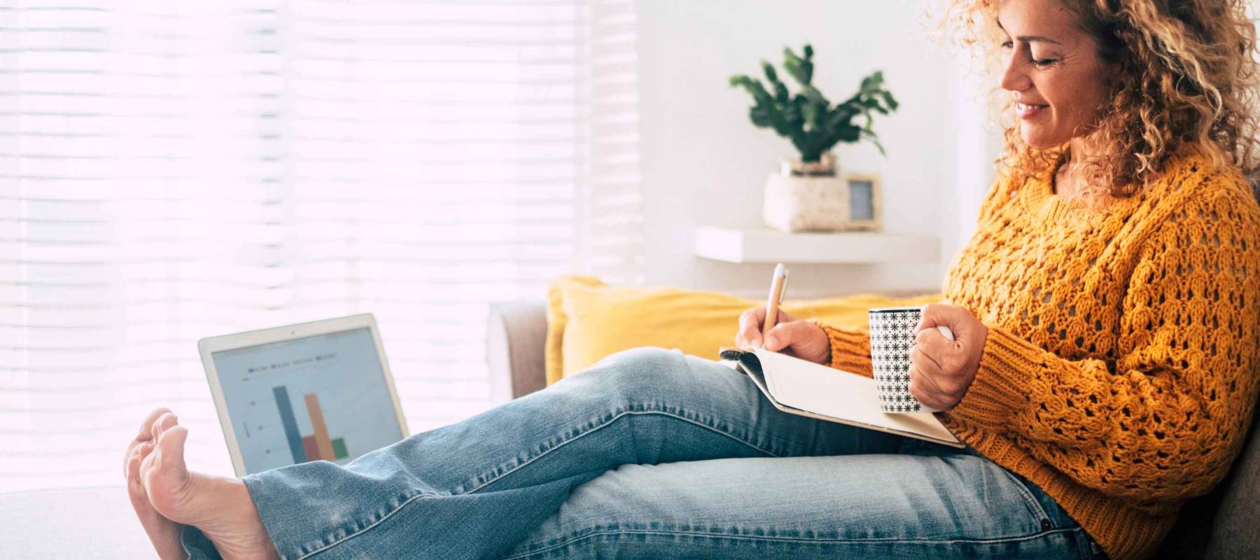 Beautiful single woman work at home with paper book and computer laptop together in old and modern job style concept