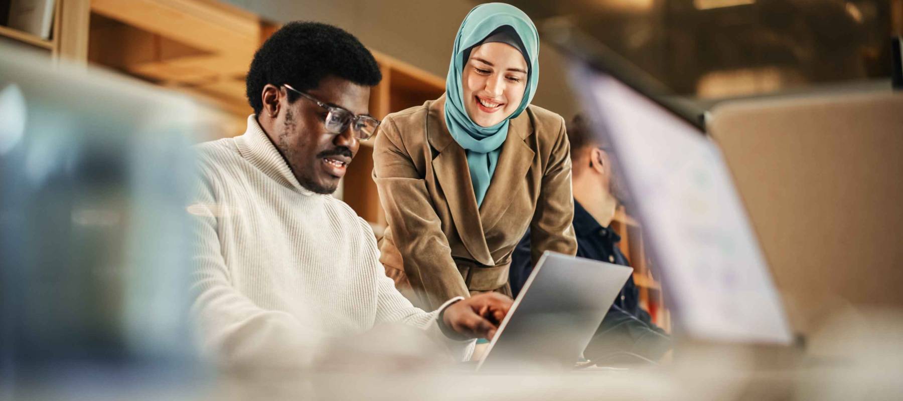 Two Coworkers Talking and Congratulating Eachother with a High Five. Muslim Female Chief Strategist Motivating Black Male Colleague,