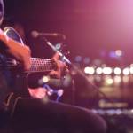 Guitarist on stage for background, soft and blur concept