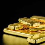 close up pure gold bar ingot put on the black color leather surface background represent the business and finance concept idea