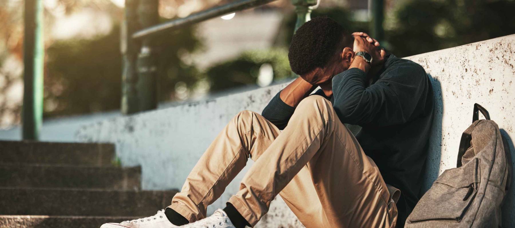 Young man, stressed and tired on university or college campus