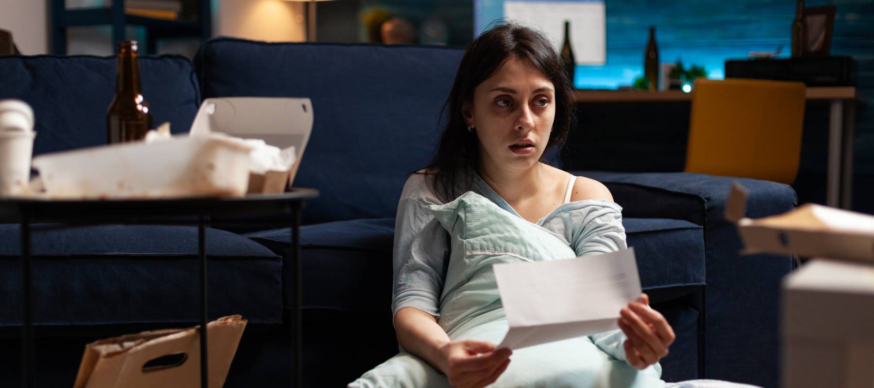 Disappointed, frustrated, depressed, desperate young woman sitting on floor