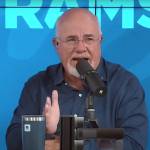 Dave Ramsey looks incredulous as he speaks into a microphone on the set of his radio show.