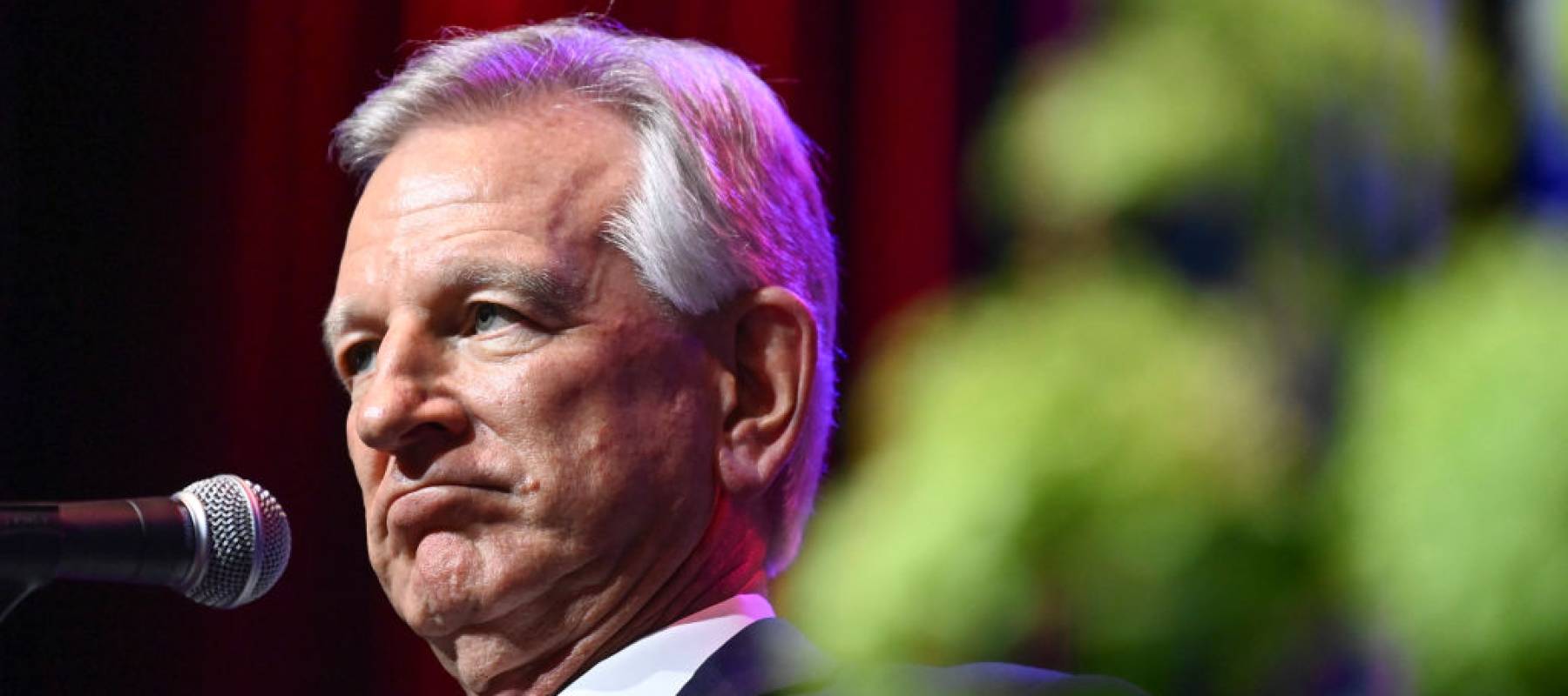 U.S. Sen. Tommy Tuberville speaks on stage at a campaign event.