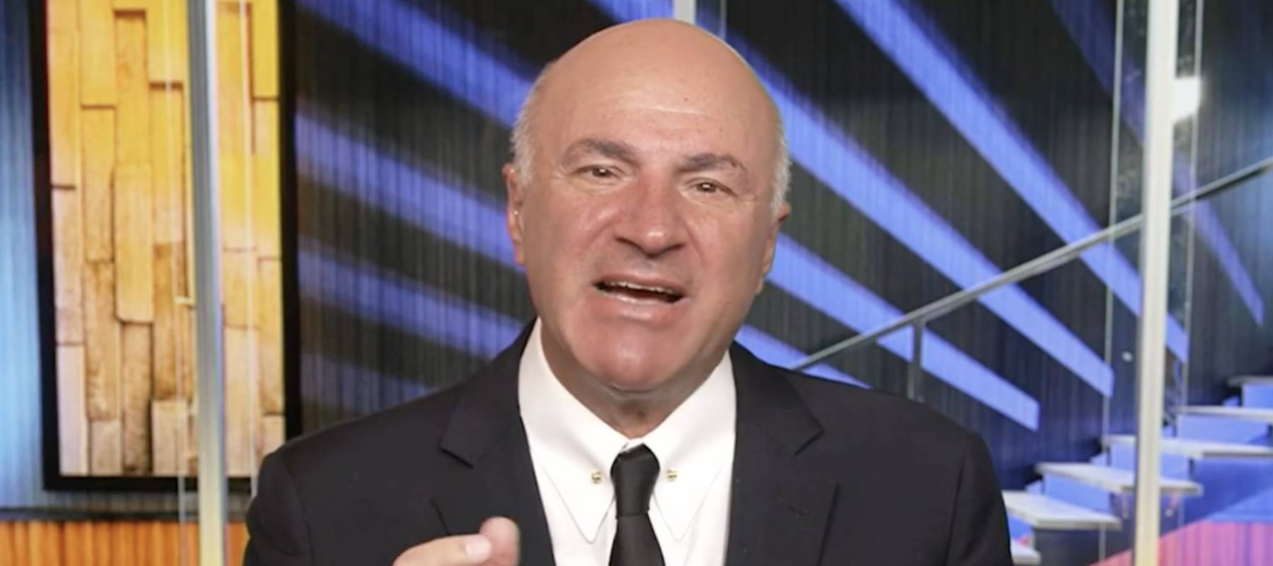 Kevin O&#039;Leary seen on set of Fox News, speaking with seriousness.