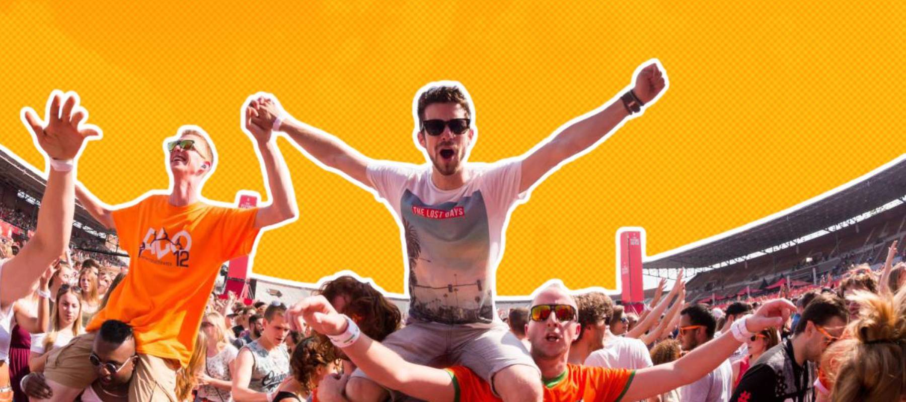 two young white men sitting on their friends' shoulders at an outdoor concert