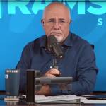 Dave Ramsey speaks into the microphone making a sassy face while on set of his radio show.