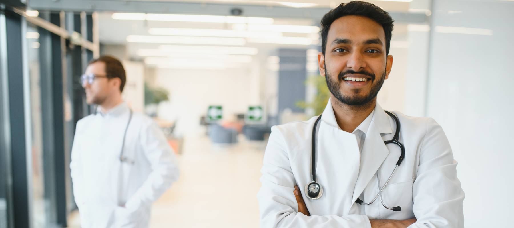 Smiling doctor with arms crossed