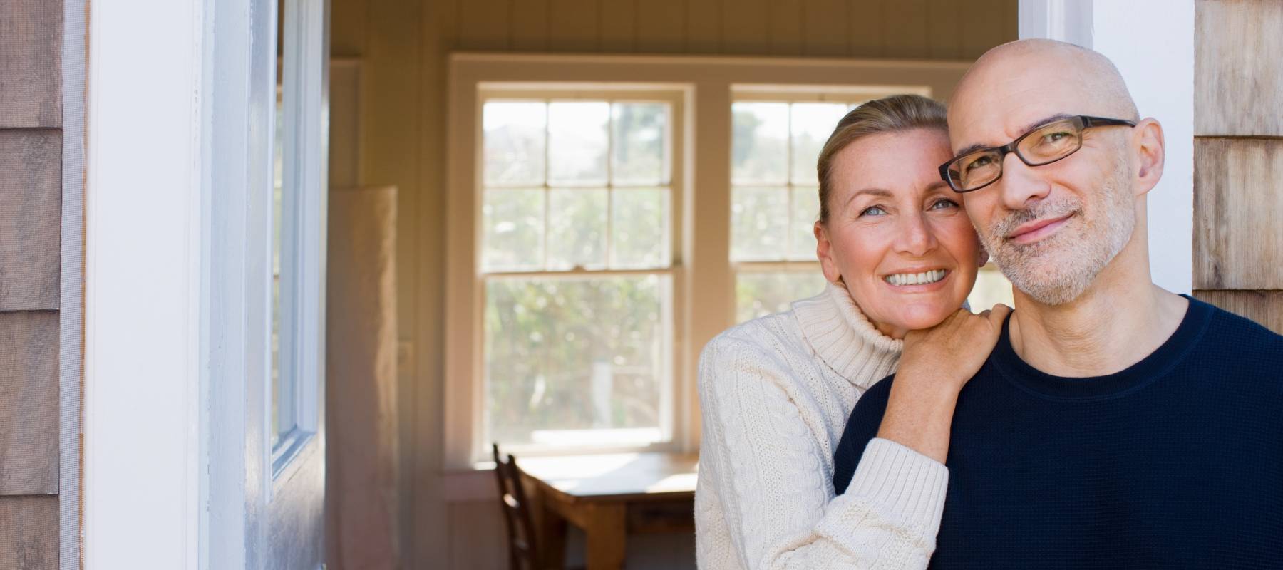 Couple smiles in doorway