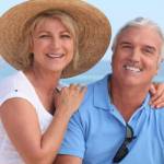 Happy retired couple on the beach