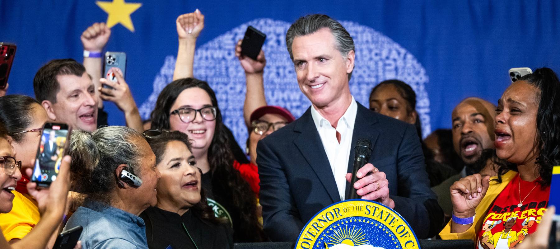 California Gov. Gavin Newsom signs legislation raising the state&#039;s fast-food worker minimum wage to $20 an hour at SEIU Local 721 in Los Angeles, Sept. 28, 2023.