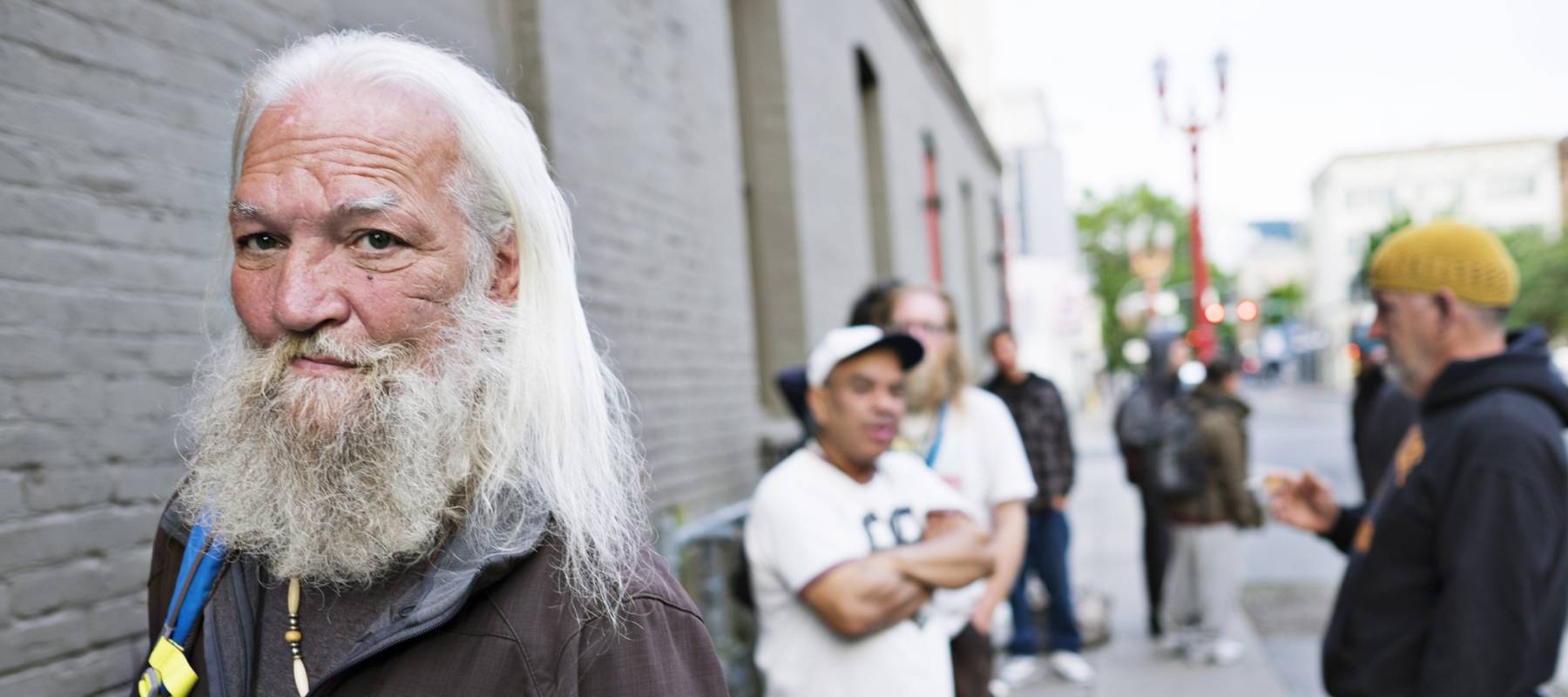 Homeless men wait in line for a shelter to open.