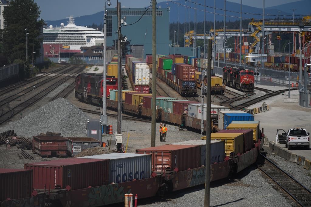 A CN Rail train moves cargo containers at the Centerm Container Terminal at port in Vancouver, on Friday, July 14, 2023.The Vancouver Fraser Port Authority says container shipments are fallin