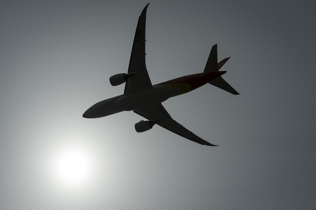 A plane is silhouetted as it takes off from Vancouver International Airport in Richmond, B.C., on May 13, 2019. 