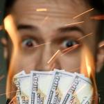 A person watches cash burn.