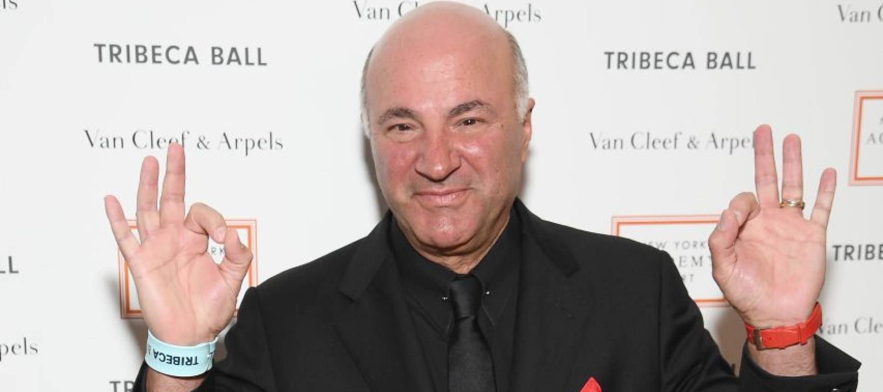 Kevin O'Leary attends an event in New York City, posing happily holding up the peace sign with both hands.