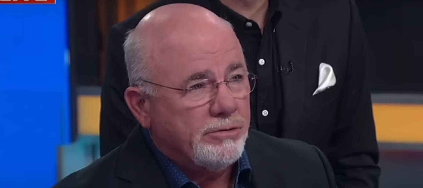 Still of Dave Ramsey speaking to a camera on the set of Fox and Friends television show.