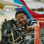 An aircraft mechanic student practices her craft.