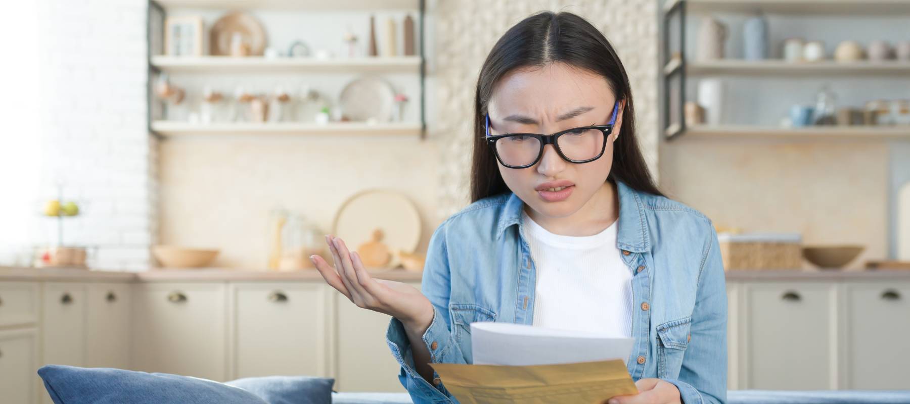 A woman is displeased by a letter.