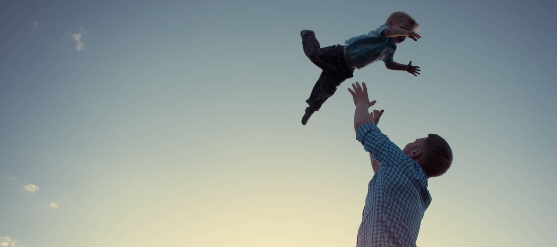 Father tossing his son