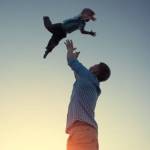 Father tossing his son