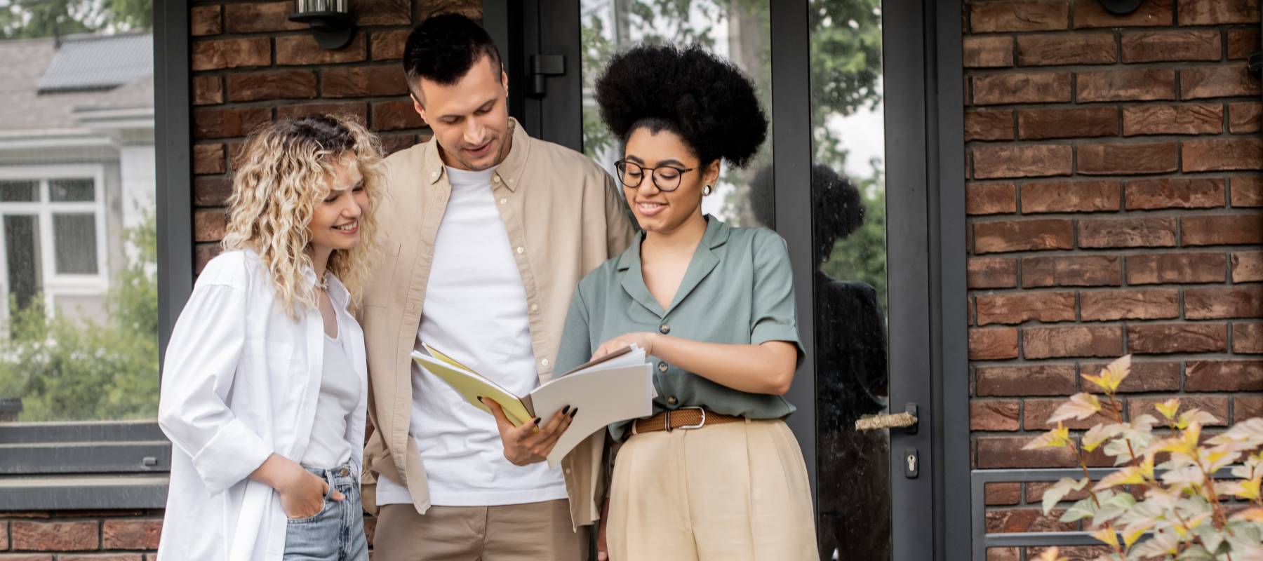 A realtor showing documents to prospective homebuyers.