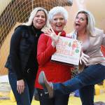 Twin sisters Chanda Bell and Christa Pitts celebrate with their mother, "The Elf on the Shelf" co-author Carol Aebersold in 2012.