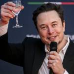 Elon Musk, chief executive officer of Tesla Inc and X (formerly Twitter) Ceo speaks at the Atreju political convention organized by Fratelli d'Italia, raising a glass in his hand.