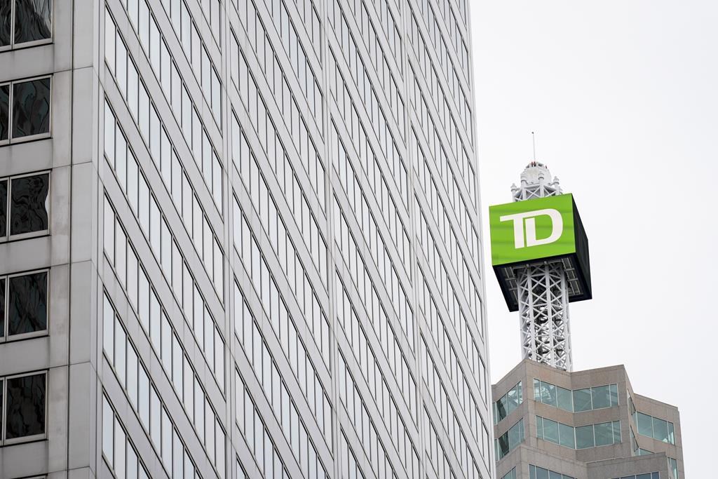 TD Bank signage is pictured in the financial district in Toronto, Friday, Sept. 8, 2023. TD Bank Group says it expects to earn about 30 per cent less from its Charles Schwab Corp. holdings in