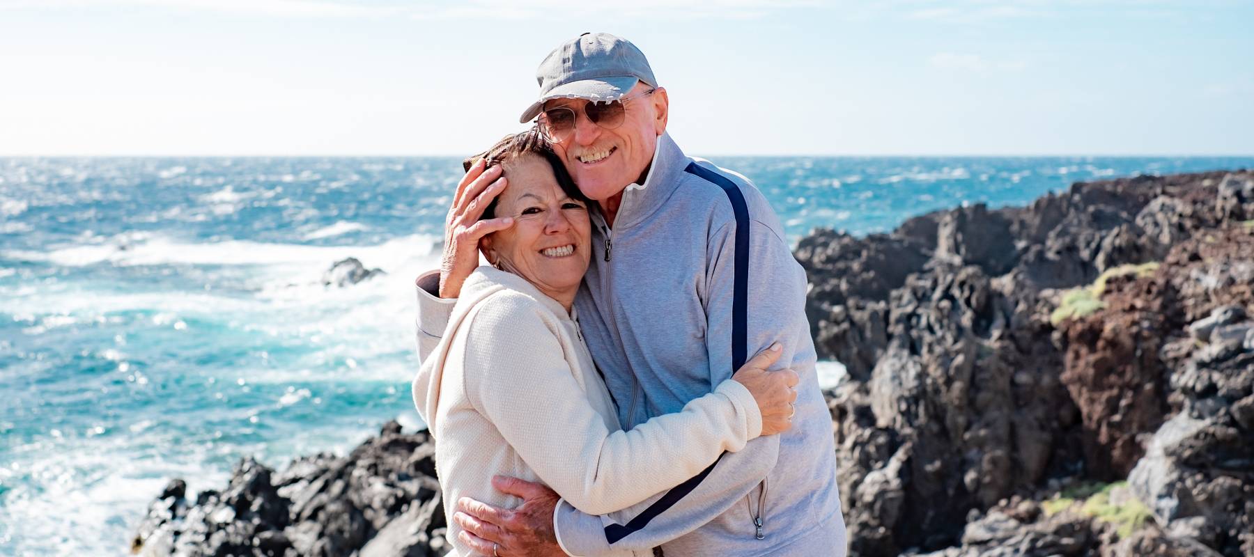 A happy older couple enjoy a sunny day.