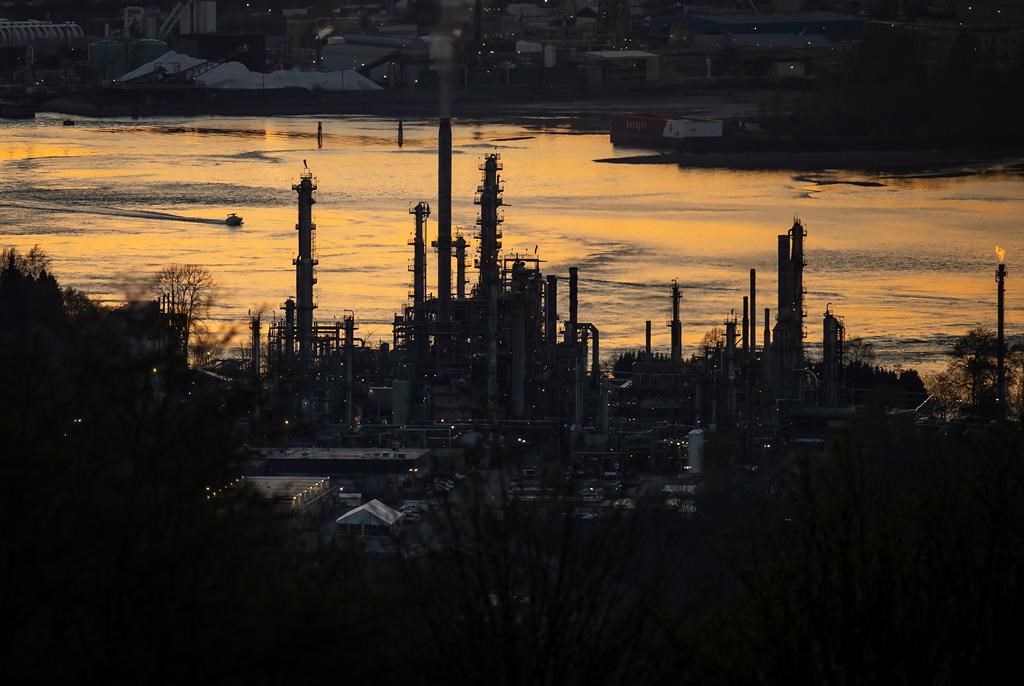 Parkland Corp. says it has temporarily shut down fuel processing at its Burnaby, B.C. refinery. A boat travels past the Parkland Burnaby Refinery on Burrard Inlet at sunset in Burnaby, B.C., 