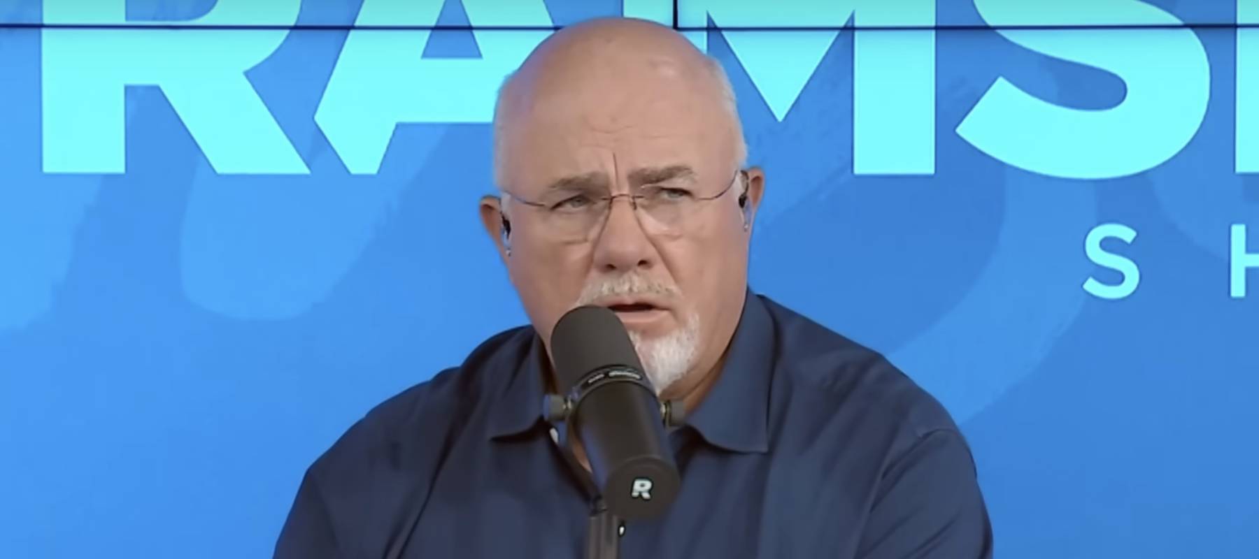 Dave Ramsey making a shocked face on the set of his podcast.