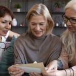 Old friends read a letter together.