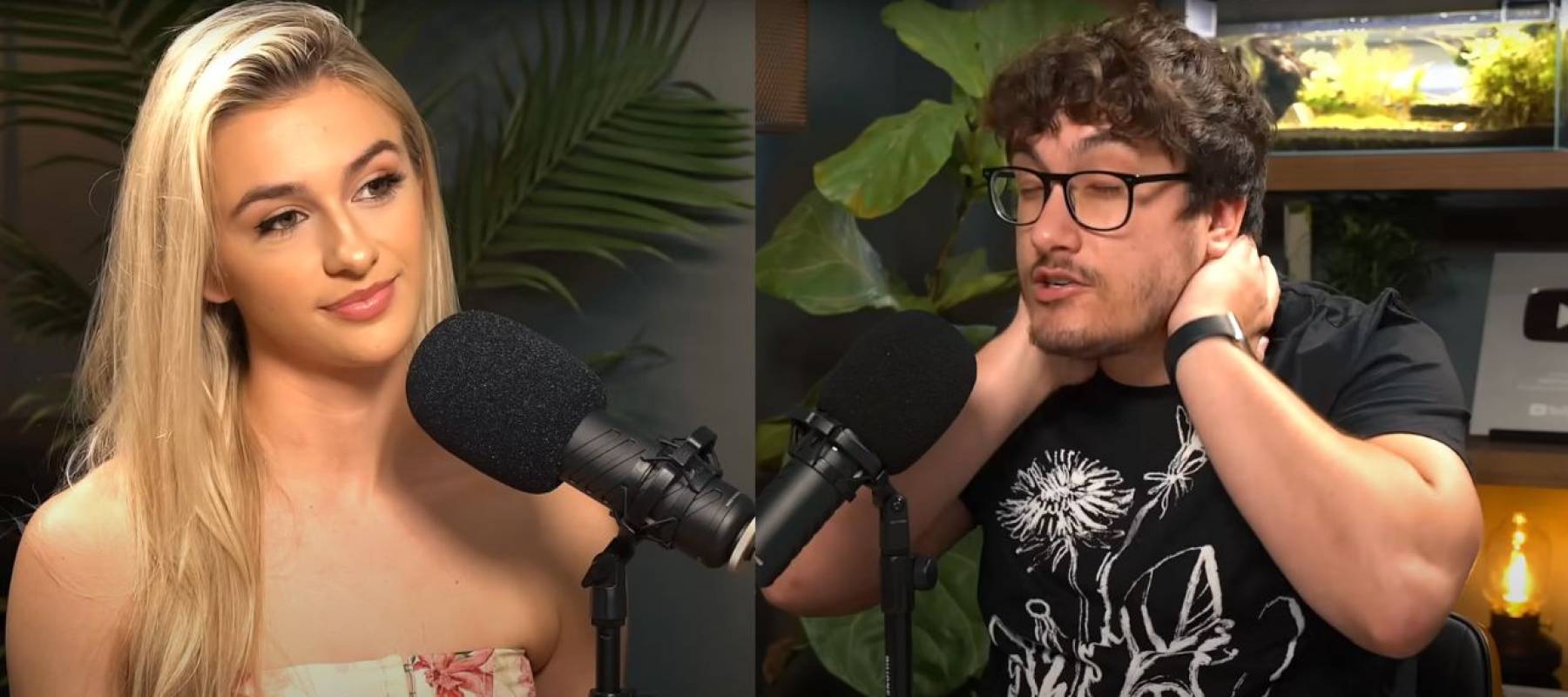 Young blonde woman seen facing young man with glasses, holding his neck in a gesture of frustration,