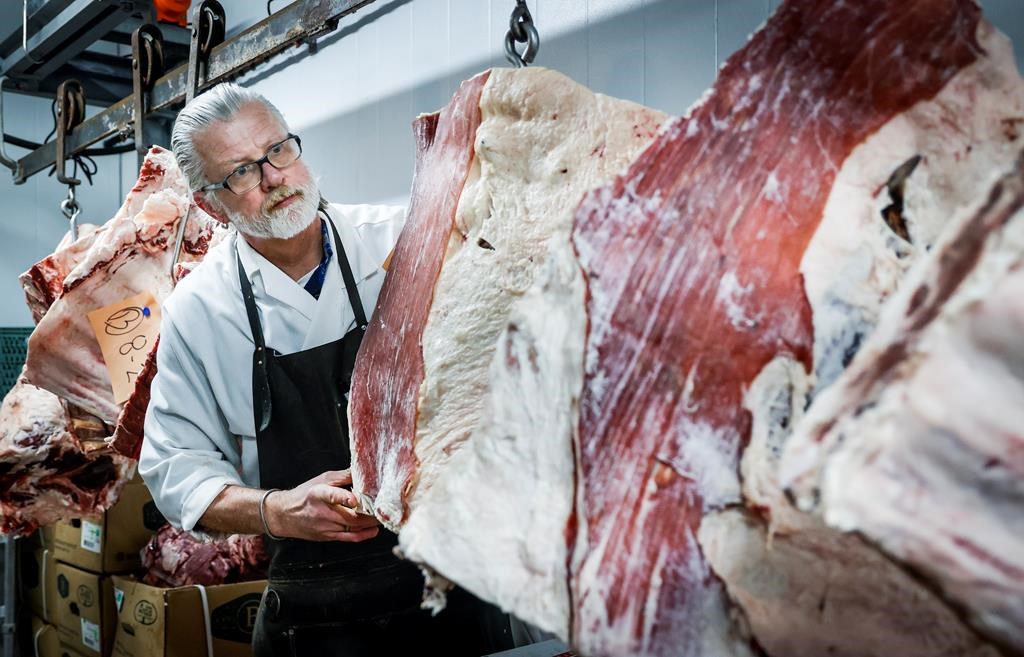 Butcher John Wildenborg works in his independent meat shop in Calgary, Wednesday, Feb. 14, 2024. 