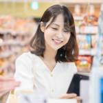 Young woman using self-checkout and e-money payment