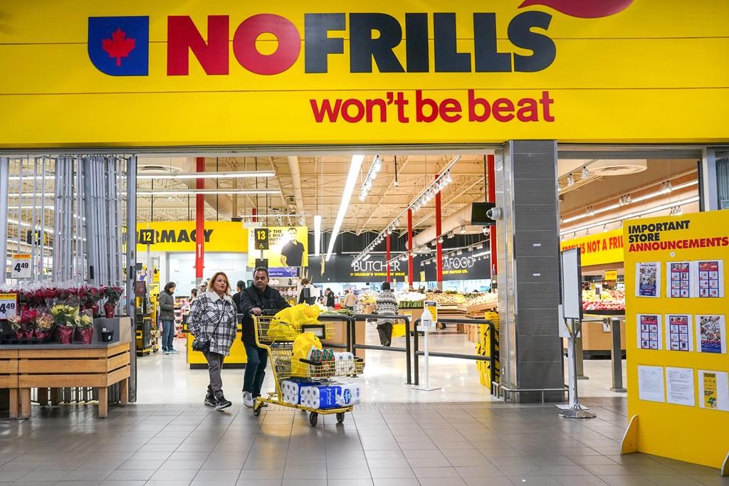 Canada&amp;rsquo;s biggest grocers are investing money and space in discount stores like No Frills, Food Basics and FreshCo as shoppers look for ways to save on food. A customer pushes a shopping
