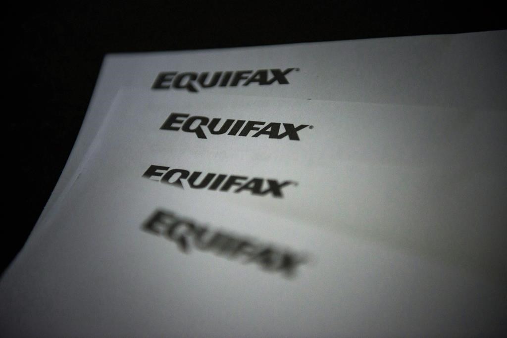 Equifax logos are shown on paper in Toronto on Oct.17, 2019. Equifax Canada says Ontario and British Columbia saw mortgage delinquency rates soar in the fourth quarter of 2023, surpassing pre