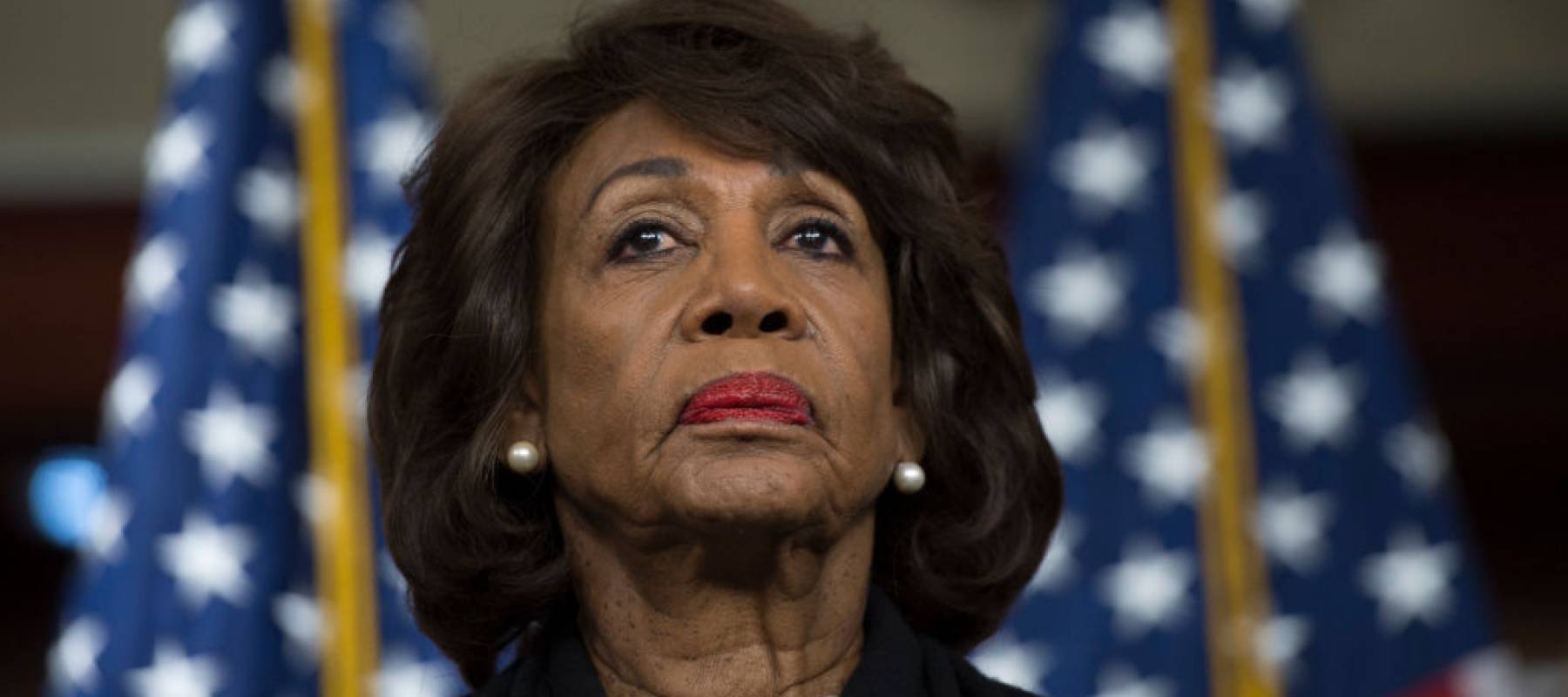 US Representative Maxine Waters (D-CA) looks on before speaking to reports regarding the Russia investigation on Capitol Hill in Washington, DC on January 9, 2018.