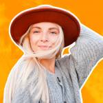 Happy woman wear trendy autumn outfit smiling over urban background.