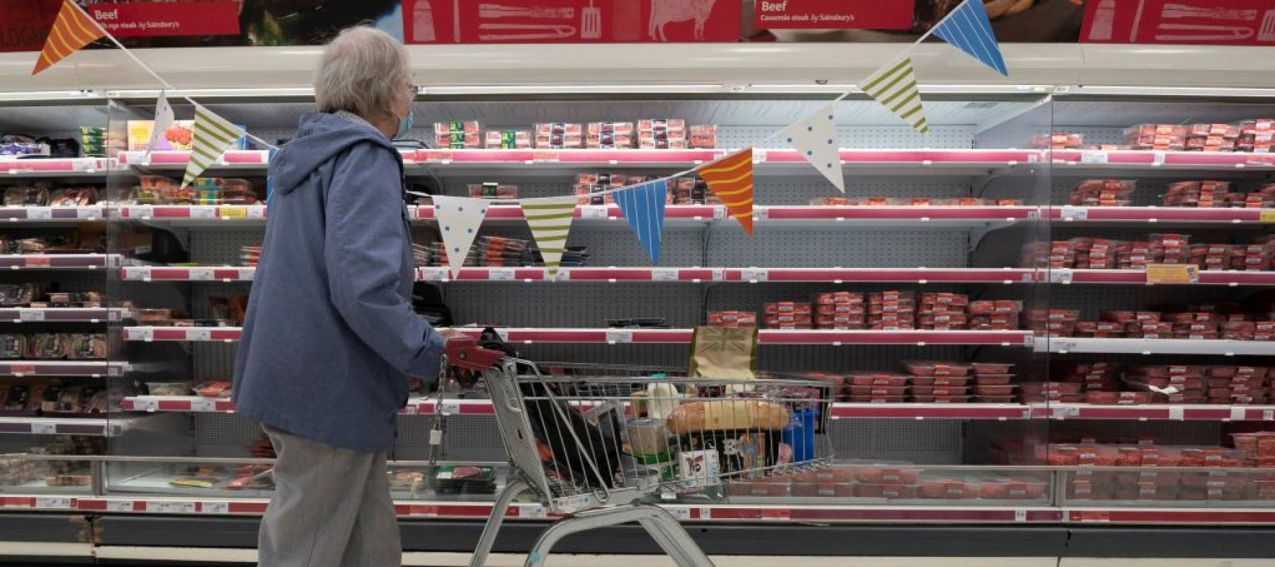 empty spaces are seen on shelves at a supermarket