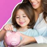 Mother and daughter putting coins into piggy bank while sitting on sofa