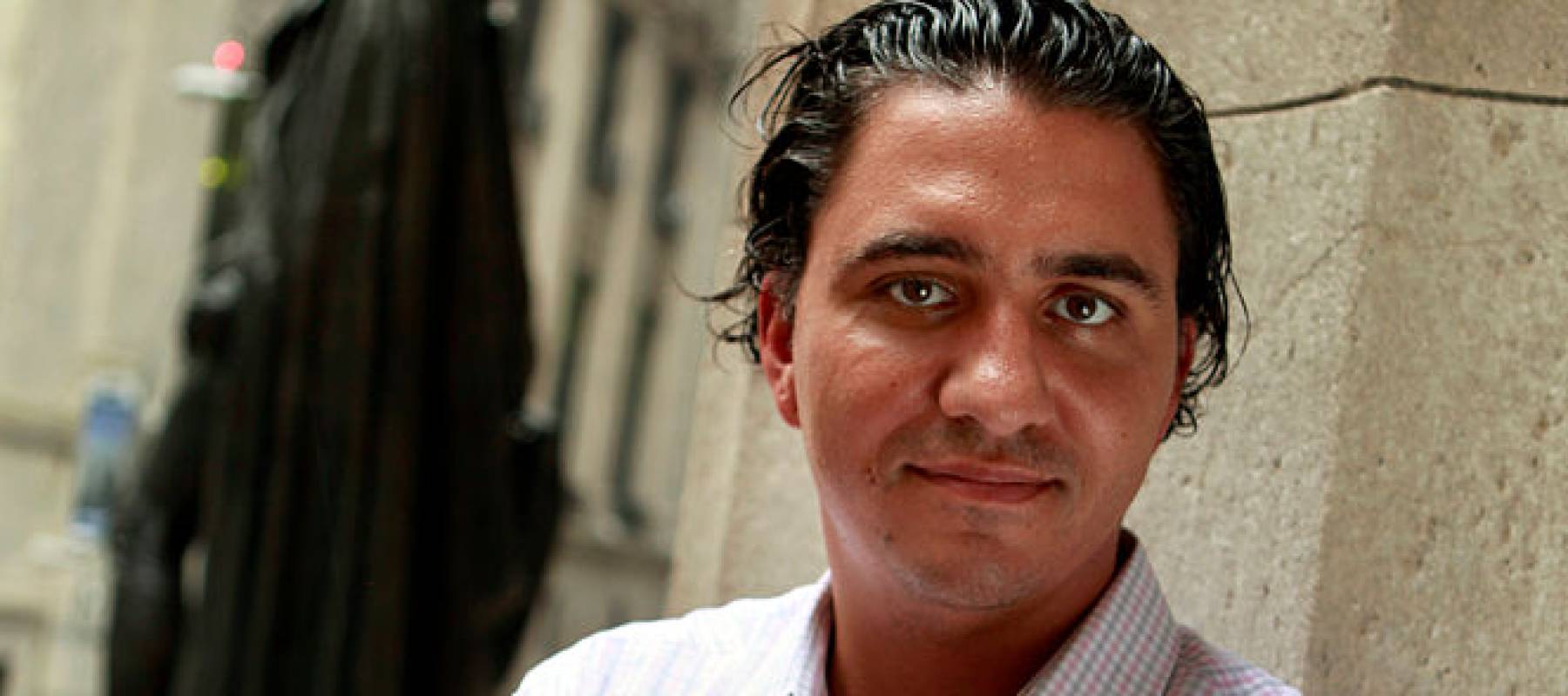 Jared Dillian pictured with his arms crossed on Wall Street.