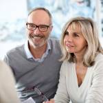 Couple meeting financial adviser to enquire about senior checking accounts